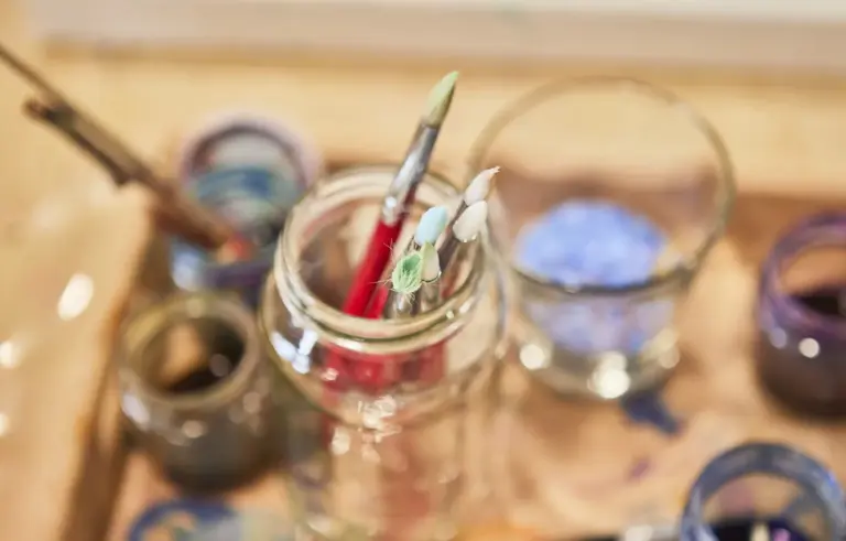 Paintbrushes and art materials arranged for creative play.