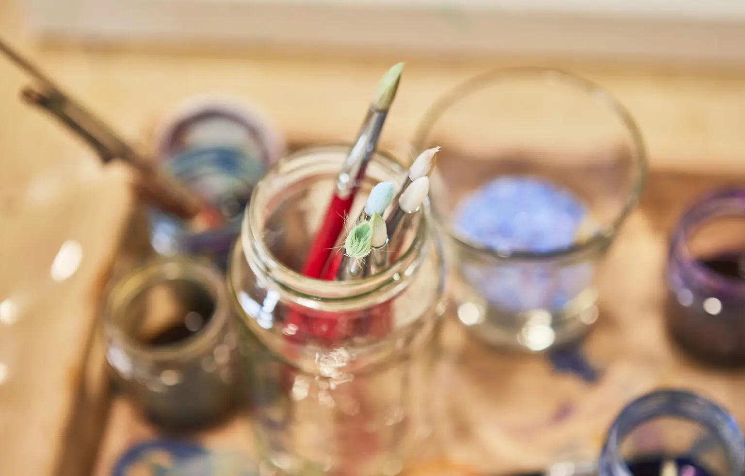 Paintbrushes and art materials arranged for creative play.