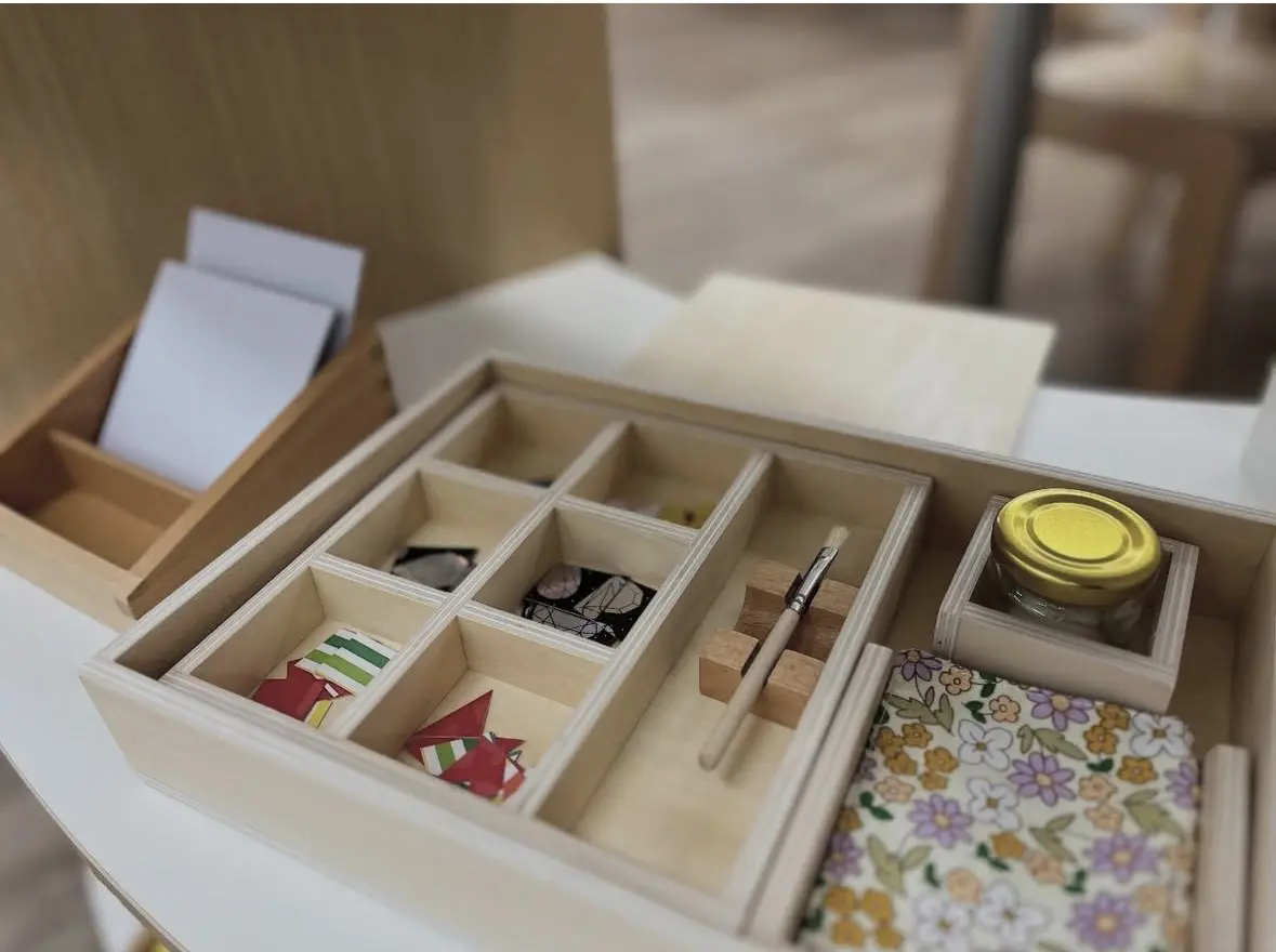 A divided tray holding a variety of loose parts for open-ended play.
